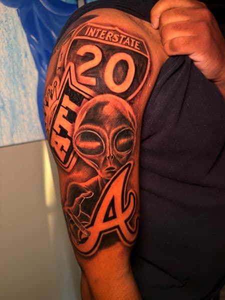 Black & Grey + Lettering alien tattoo on Upper Arm by ARTWORLDINK on TattMe
