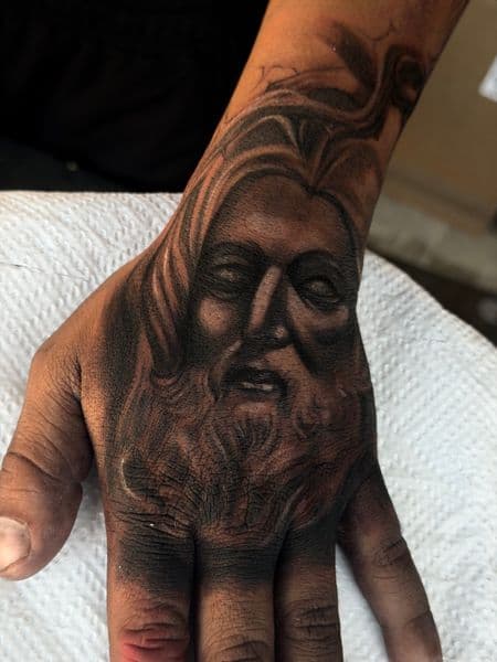 Black & Grey + Realism face tattoo on Hand by inkryptd on TattMe