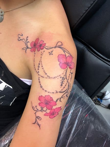 Floral + Fine Line flowers tattoo on Upper Arm by jules.inkz on TattMe