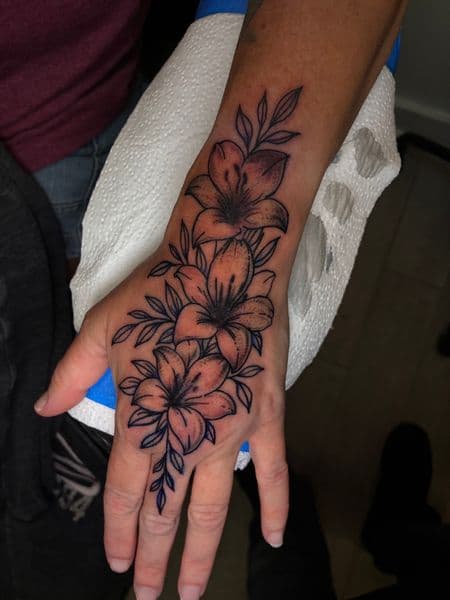 Floral + Fine Line flowers tattoo on Hand by jules.inkz on TattMe