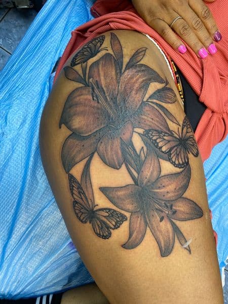 Black & Grey + Floral lilies tattoo on Thigh by Tony_Hustle_215 on TattMe