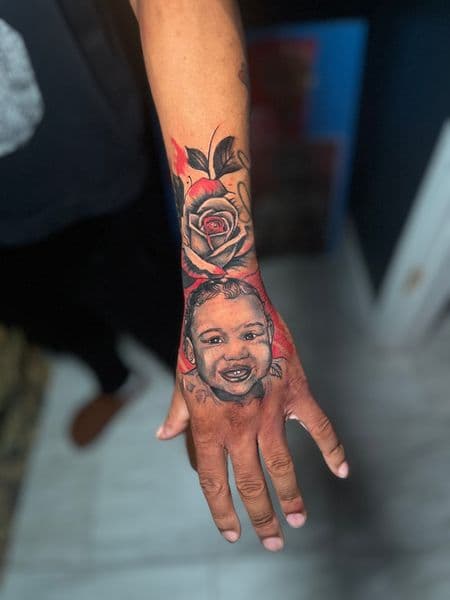Portrait Realism + Black & Grey baby tattoo on Hand by TattooHut on TattMe