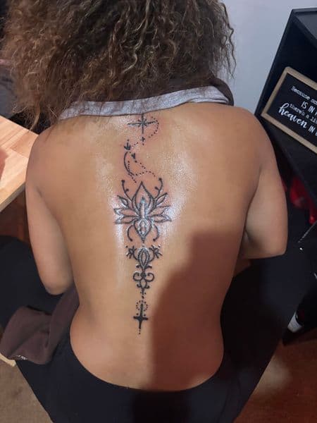Fine Line + Black-work lotus tattoo on Spine by ink_by_Nek on TattMe