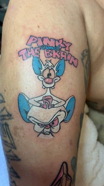 Cartoon + Pop Culture pinky and the brain tattoo on Upper Arm by PoeMyInk on TattMe