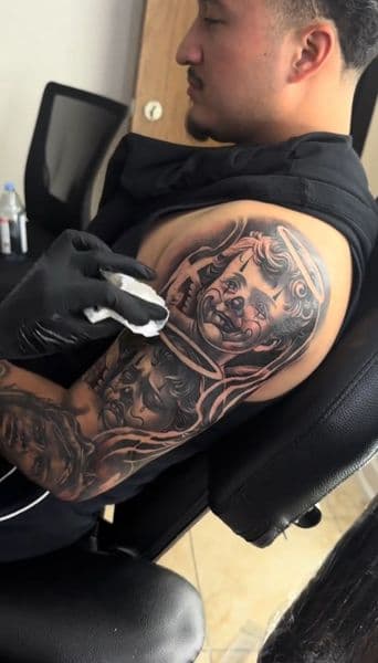 Black & Grey + Chicano cholo clown tattoo on Upper Arm by Resevoir_tattoo_artist on TattMe