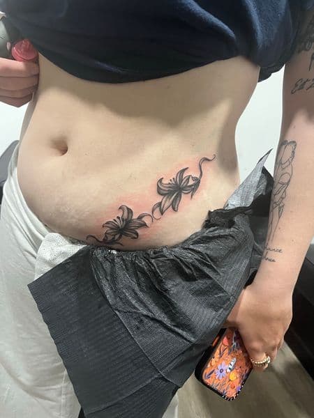 Black & Grey + Floral lilies tattoo on Stomach by AnimatedLifestyle on TattMe