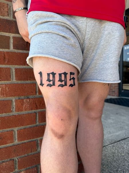 Blackwork + Script birth year tattoo on Thigh by jaae_inks on TattMe