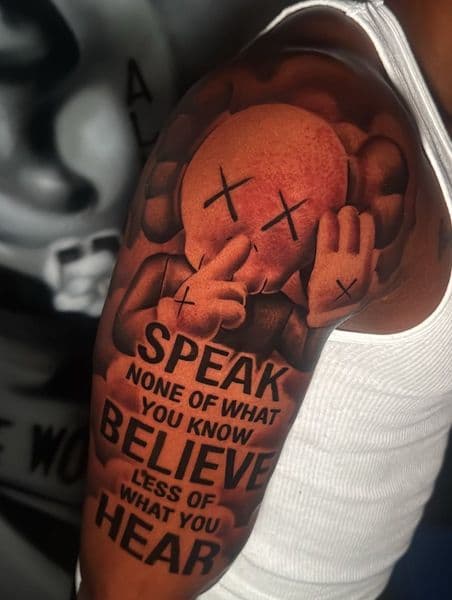 Pop Culture + Lettering kaws tattoo on Upper Arm by Hillcityink on TattMe