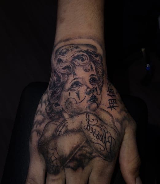 Black & Grey + Chicano cherub tattoo on Hand by kriko on TattMe