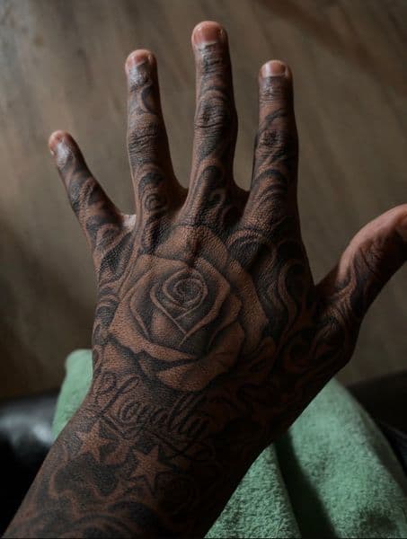Black & Grey + Illustrative rose tattoo on Hand by get_tattoo_by_jordan on TattMe