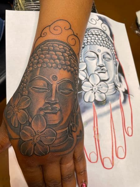 Black & Grey + Illustrative buddha tattoo on Hand by Ashley_Panda on TattMe