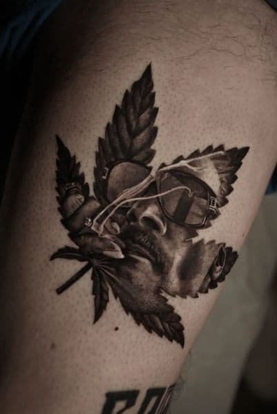 Black & Grey + Realism cannabis leaf tattoo on Thigh by Daniella on TattMe