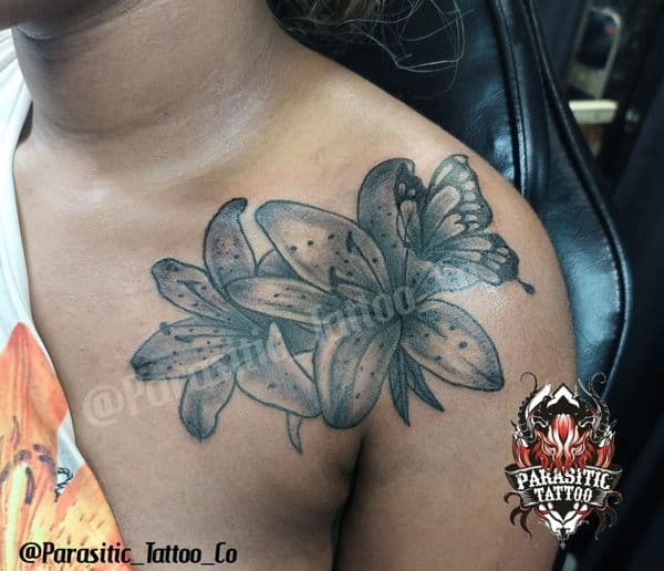 Black & Grey + Floral lilies tattoo on Shoulder by Parasitic_Tattoo_Co. on TattMe