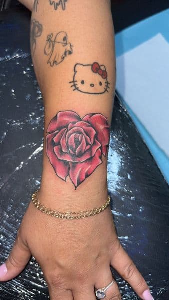 Color + Illustrative rose tattoo on Wrist by the_goat_images_ on TattMe