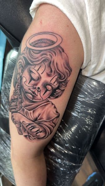 Black & Grey + Chicano cherub tattoo on Upper Arm by the_goat_images_ on TattMe