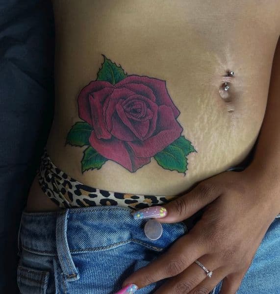 Color + Illustrative rose tattoo on Stomach by jahnovatattoo on TattMe