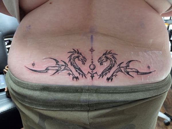 Black-work + Illustrative dragons tattoo on Lower Back by brent_holbrook_ on TattMe