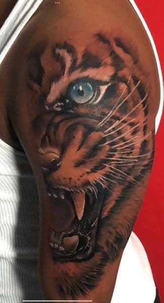Realism + Color tiger tattoo on Upper Arm by l_allen_tattoos on TattMe