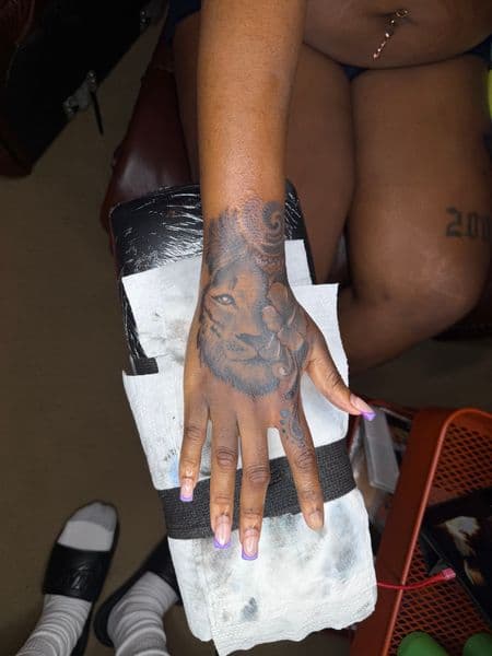 Black & Grey + Illustrative lion tattoo on Hand by itattyedyabihh on TattMe