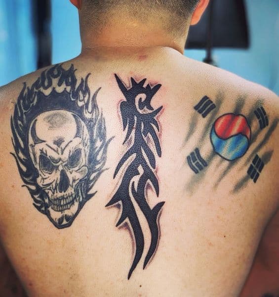 Black & Grey + Tribal skull tattoo on Upper Back by Dcmbrs_finest on TattMe