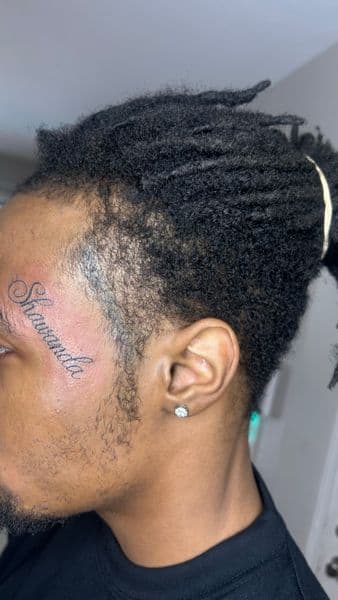 Lettering + Script name tattoo on Face by Slimxink on TattMe