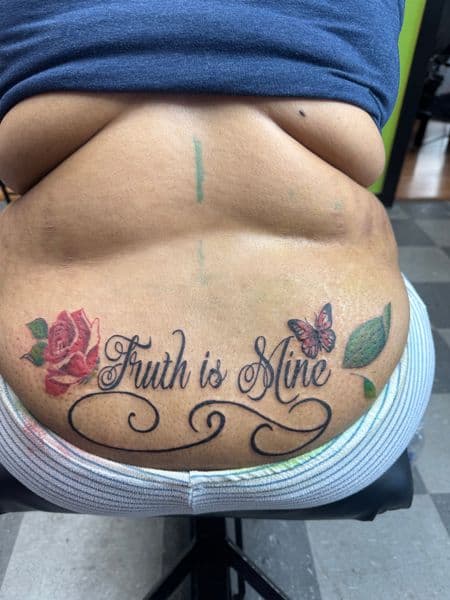 Lettering + Script rose tattoo on Lower Back by Rell_MadeYouInk on TattMe