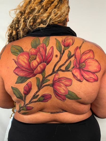 Color + Floral magnolias tattoo on Upper Back by darya on TattMe